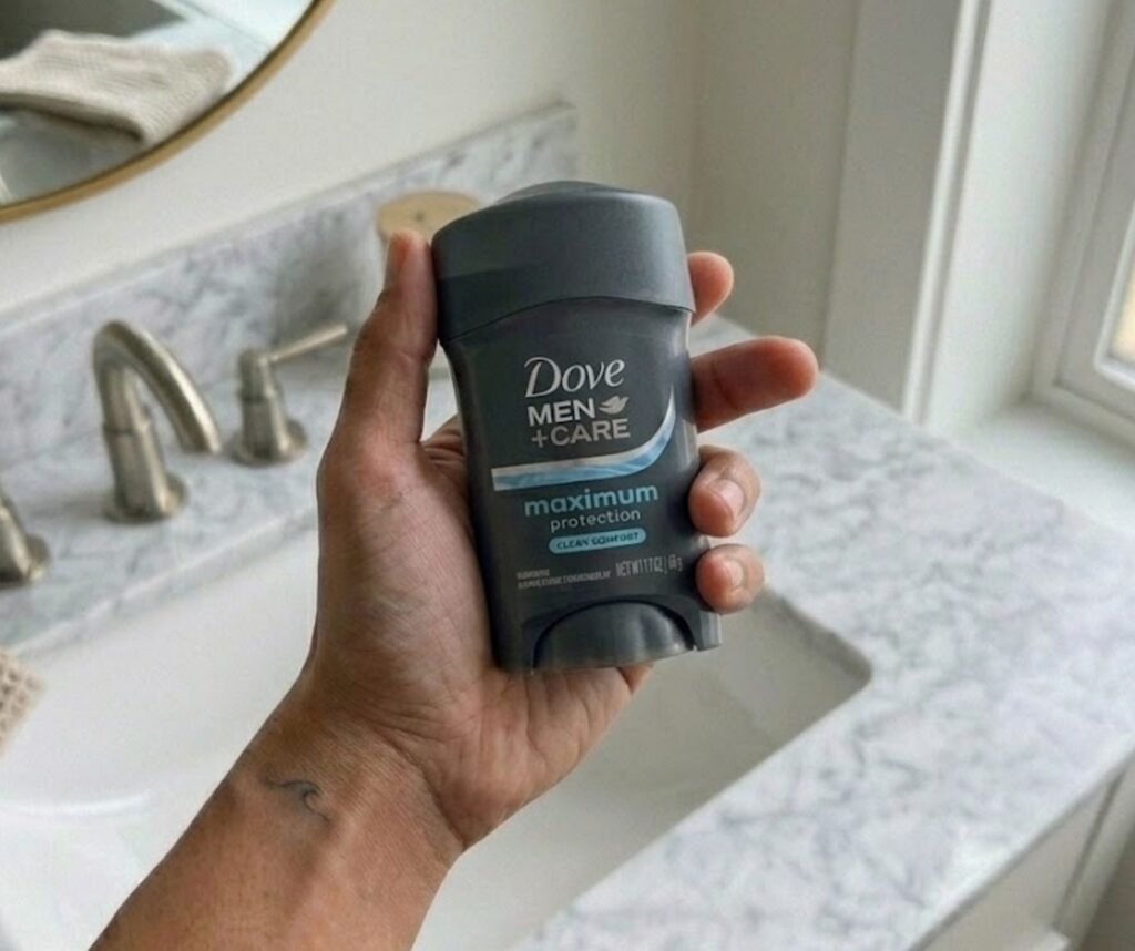Dove Men and Care Maximum Protection Clean Comfort antiperspirant stick held in a bathroom